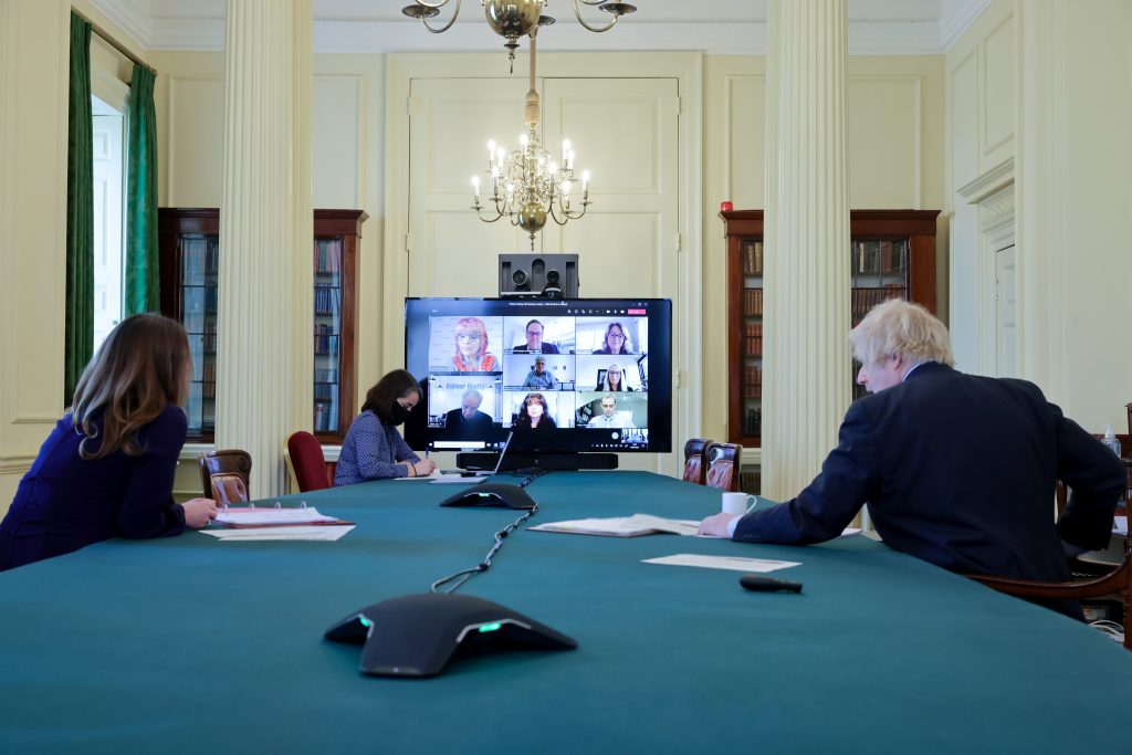 A group of people sitting around a table
Description automatically generated with low confidence